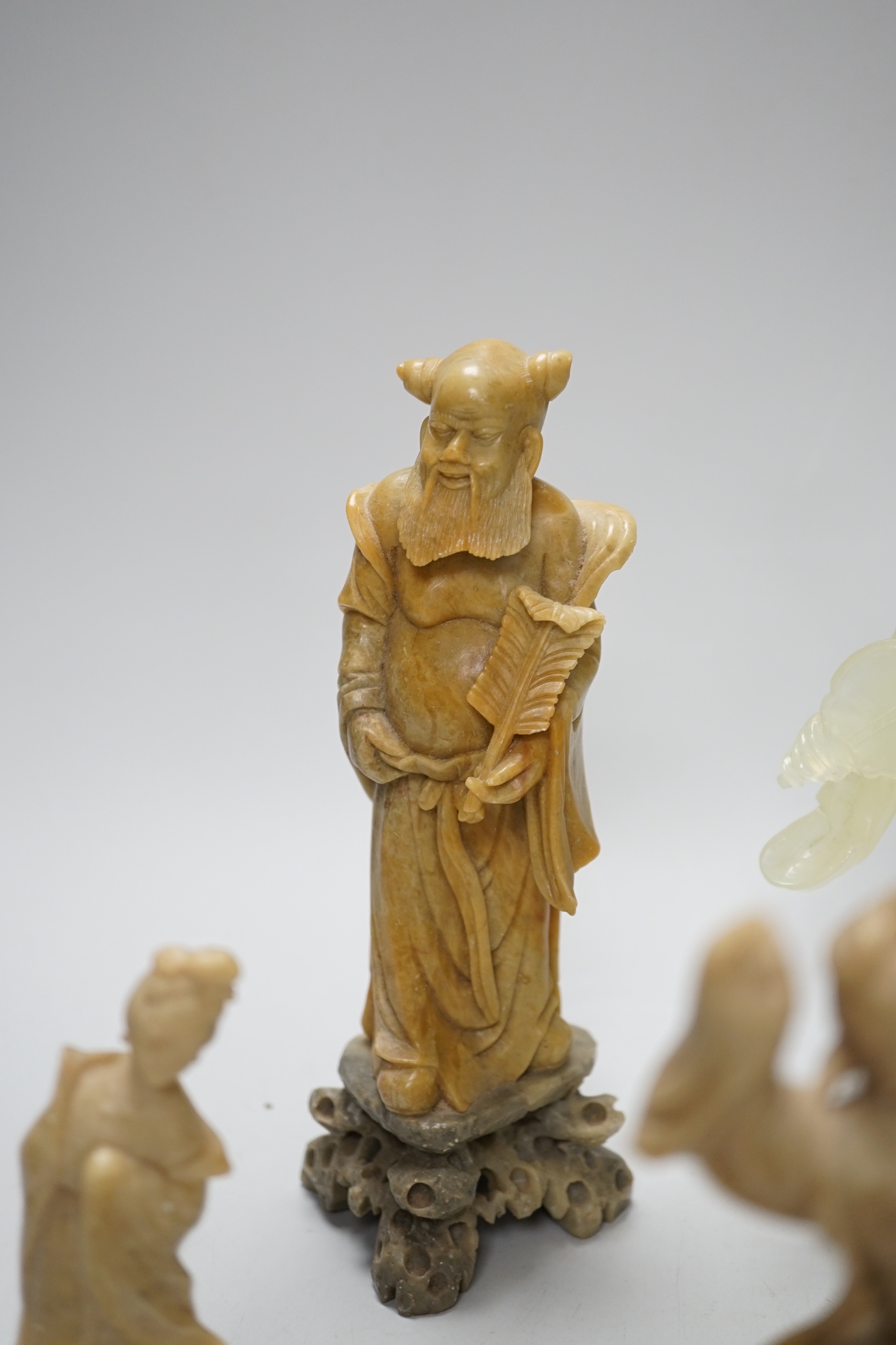 A Chinese bowenite figure and four Chinese carved soapstone figures, the largest 21cm high (5)
